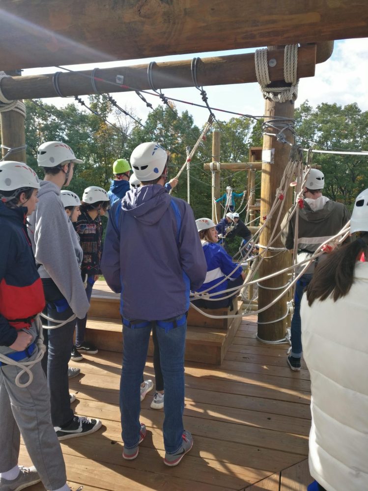 Team waiting on the platform of the high rope course
